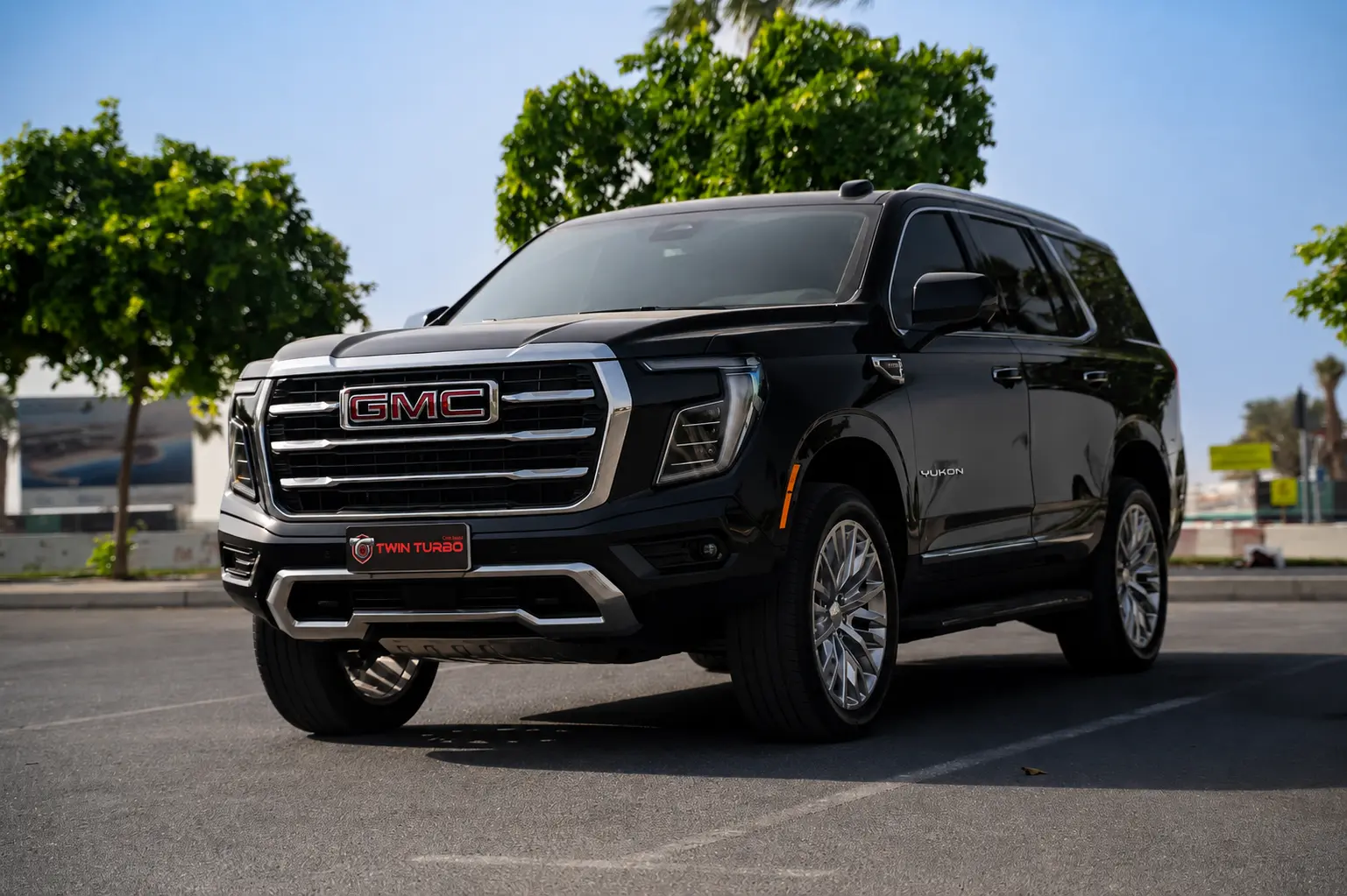 Black GMC Yukon SUV front three-quarter