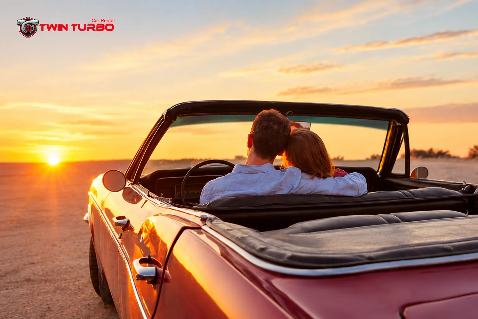 Twin Turbo Car Rental logo on a romantic sunset drive in a classic convertible, showcasing a luxury car rental experience.